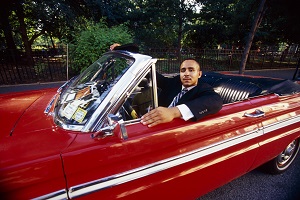 man sitting in classic car